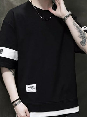 Oversized black cotton t-shirt with white contrast sleeve bands and graphic label