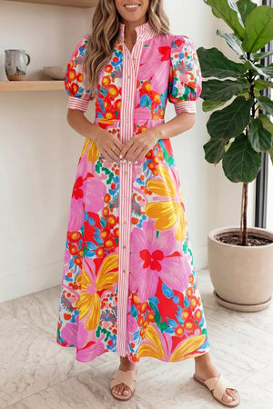 Vibrant floral maxi dress with puff sleeves, button front, and pink stripe detail.