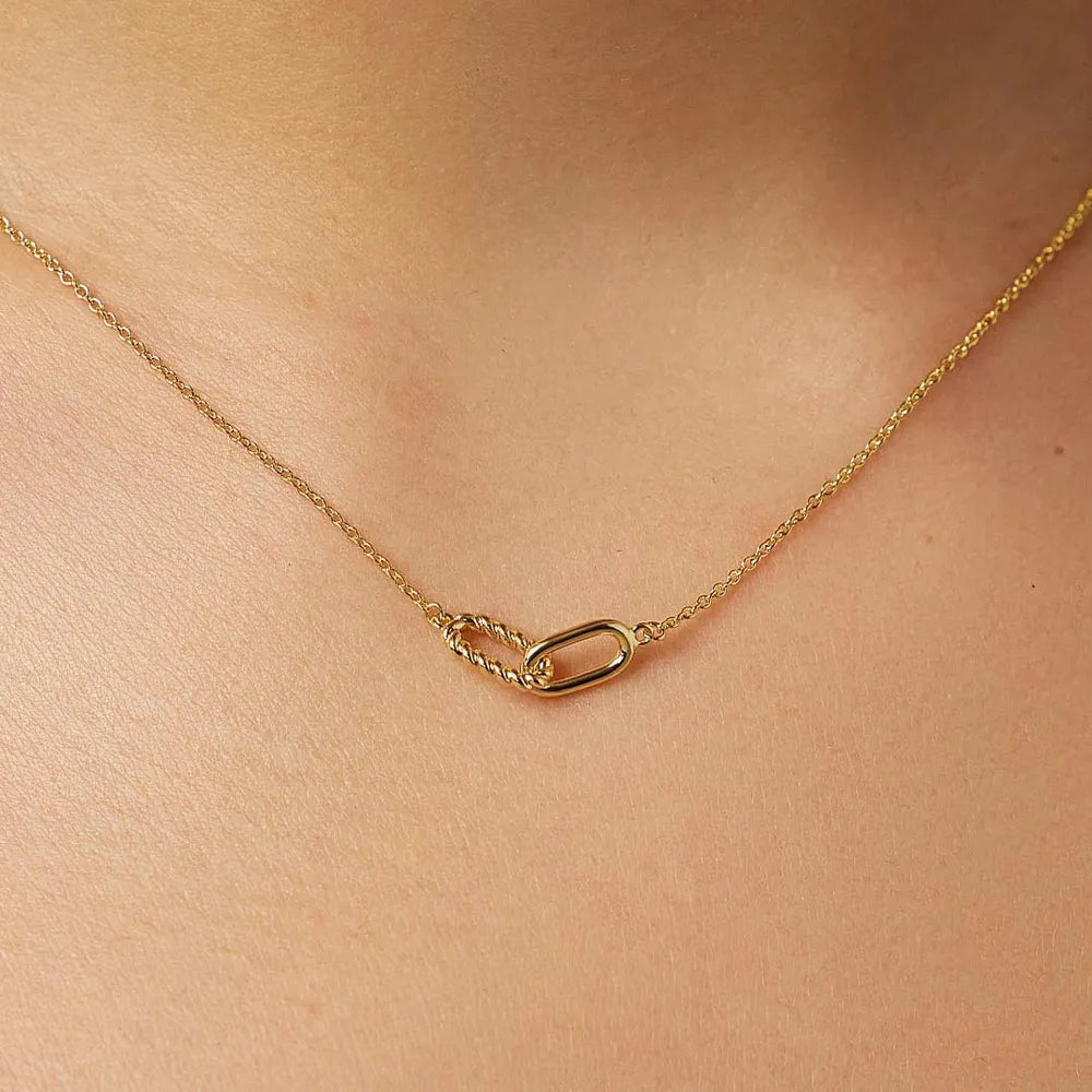 Gold interlocked link necklace with a twisted and oval link detail.