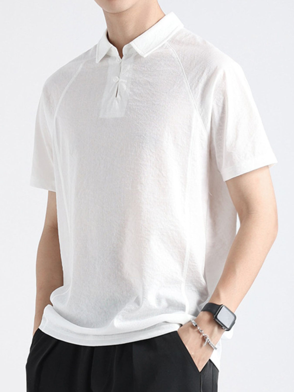 White cotton blend polo shirt with short sleeves and a two-button placket.