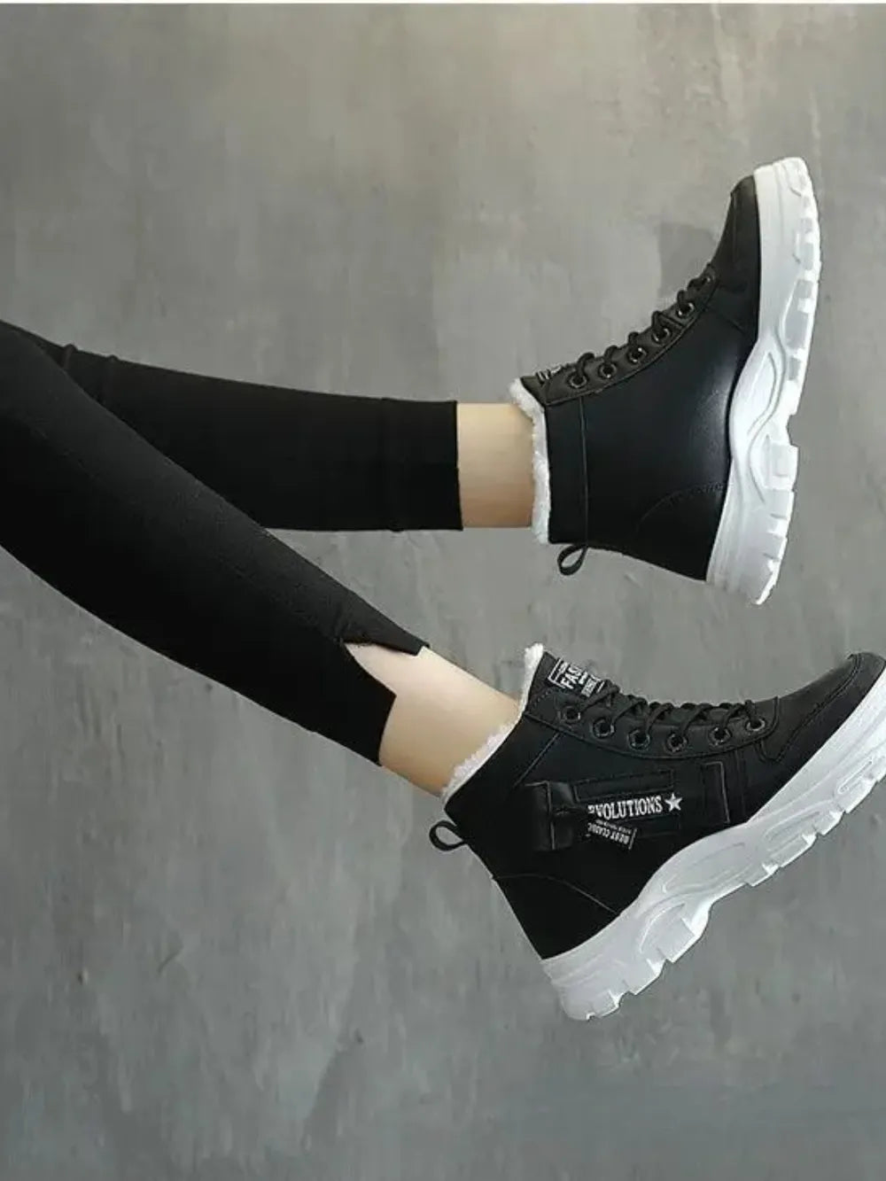 Black platform boots with faux shearling lining and white soles.
