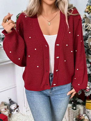 Red acrylic knit cardigan with pearl embellishments and button front.