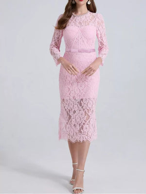 Pink lace midi dress with sheer sleeves, corseted bodice, and satin belt.