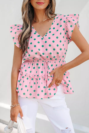 Pink polka dot blouse with ruffled sleeves and hem, V-neck, and drawstring waist.