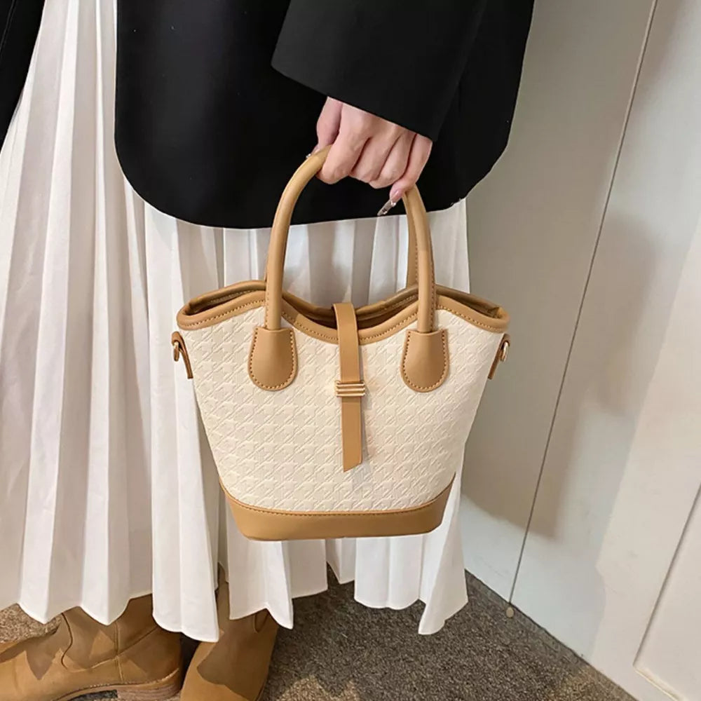 tan handbag featuring top handle and houndstooth