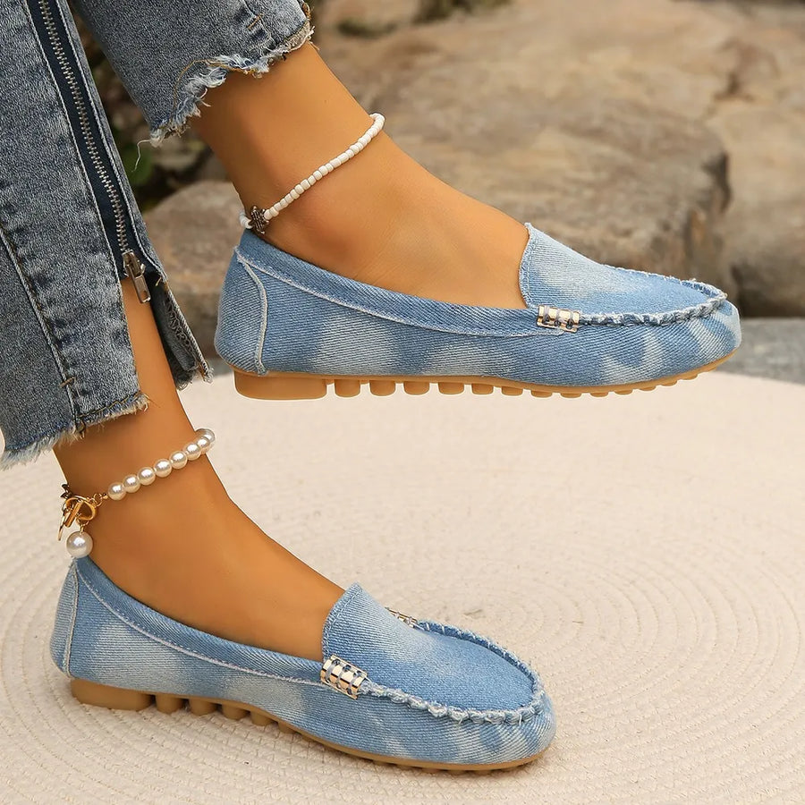 Light denim loafers with contrast stitching and metal detail.
