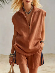 Sleeveless zip-neck linen blend top and striped shorts set in rust.