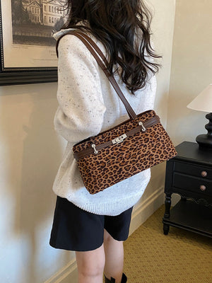 brown shoulder bag featuring decorative lock and leopard-print