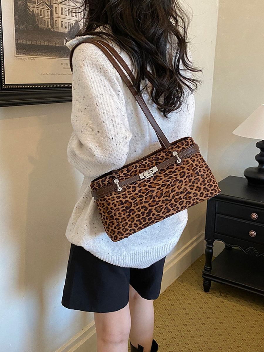 brown shoulder bag featuring decorative lock and leopard-print