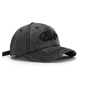 Black distressed cotton baseball cap with embroidered lettering and frayed details.