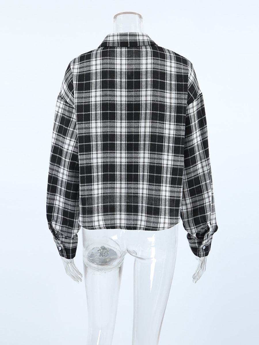 Oversized black and white plaid cotton button-up shirt with collar and cuffs.