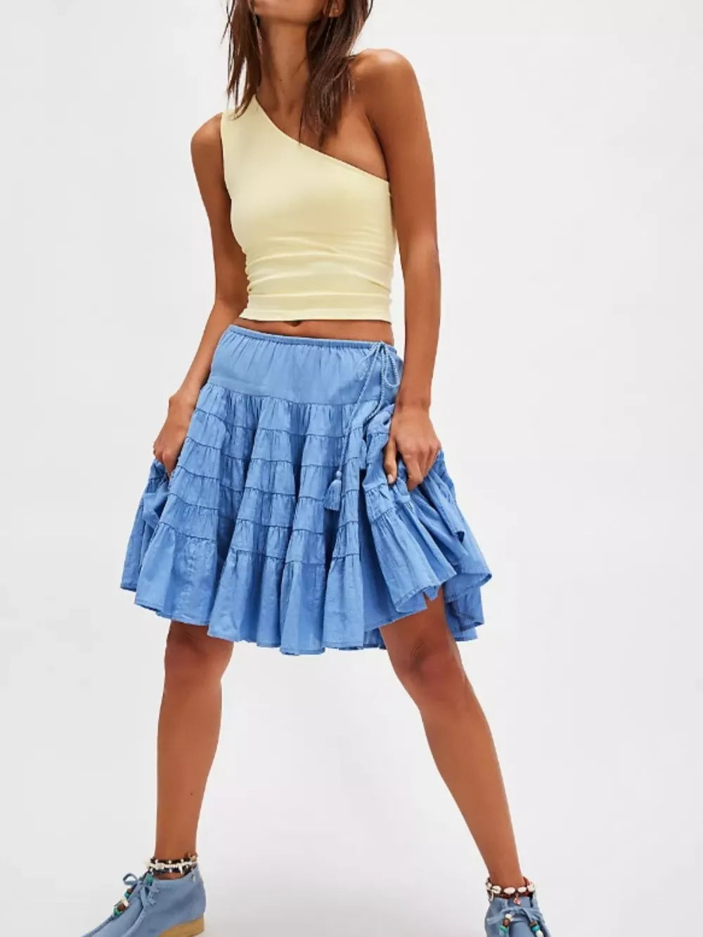 Tiered drawstring mini skirt in Sky Blue with tassel detail and ruffled tiers.