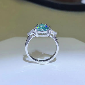 Silver ring with teardrop moissanite and pear-cut trio stones.