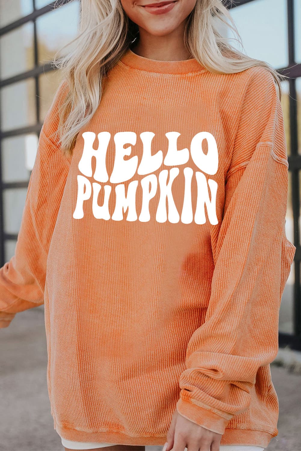 Caramel corduroy sweatshirt with white "Hello Pumpkin" graphic.