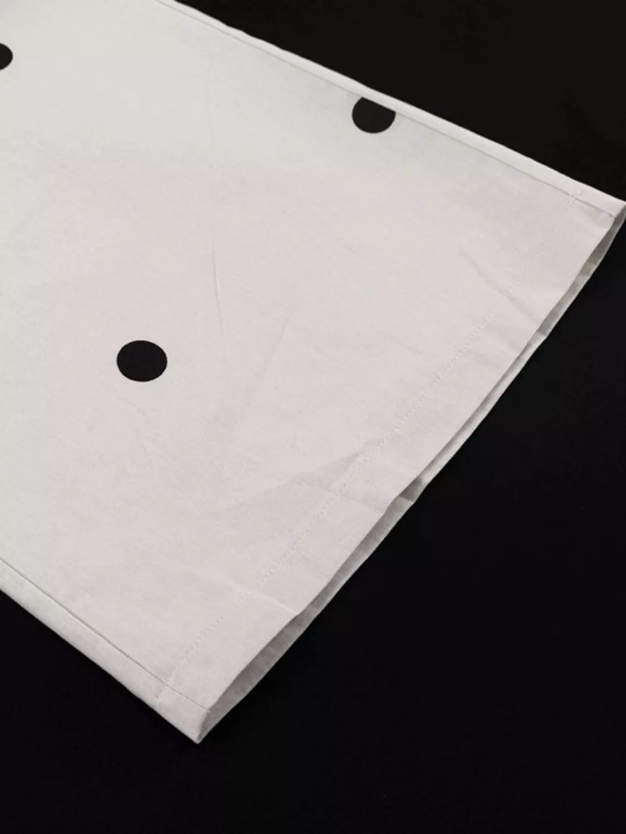 White polka dot fabric with black dots