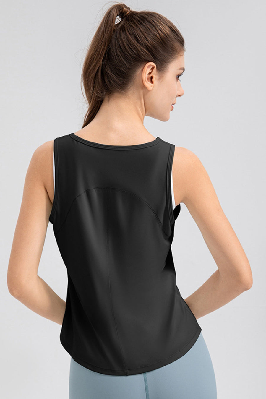 Black performance tank top with curved back panel detail