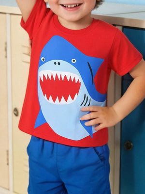 Red cotton t-shirt with a playful blue shark graphic for toddlers.