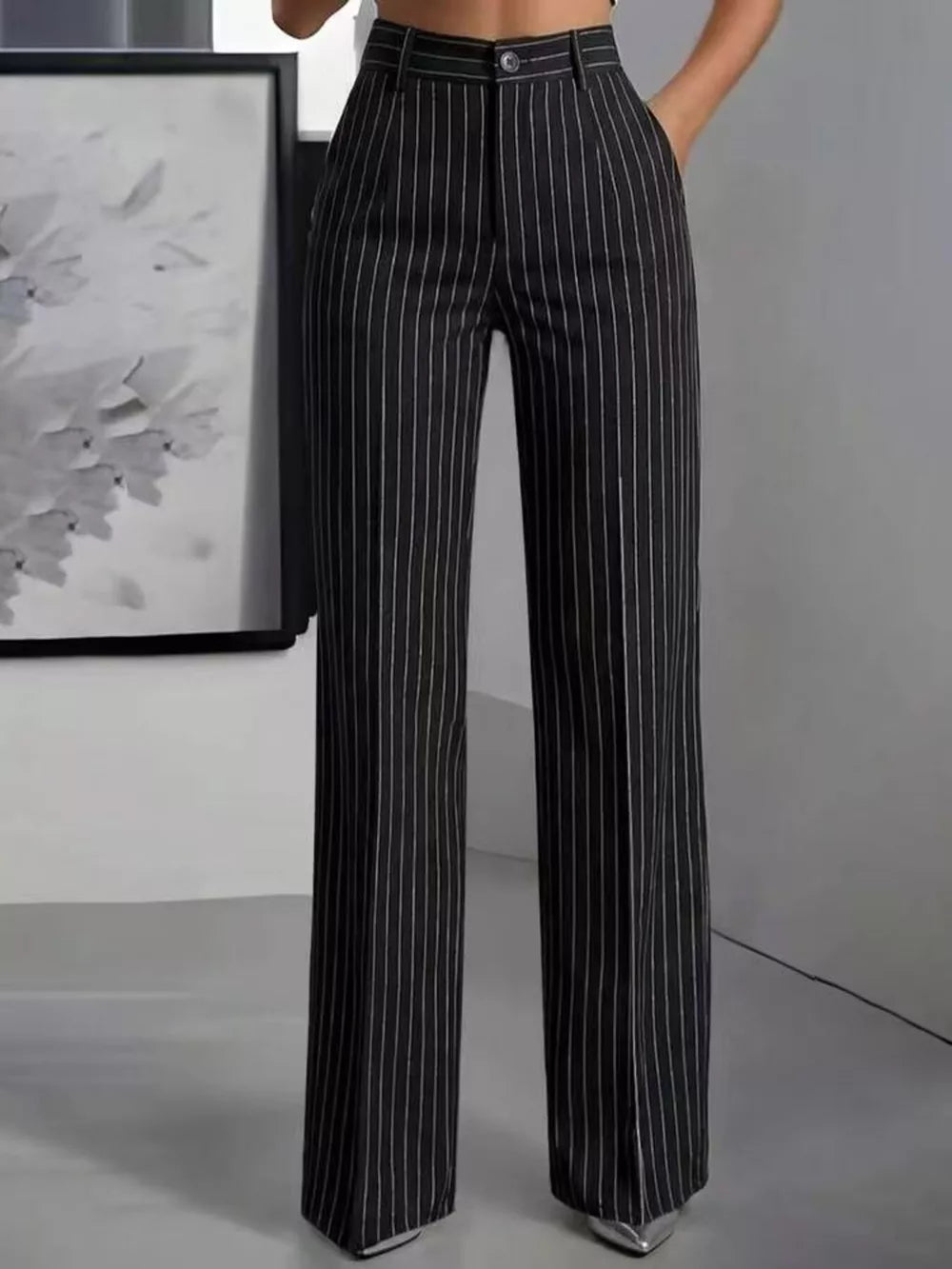 wide-leg pants in black featuring buttoned and flared fit