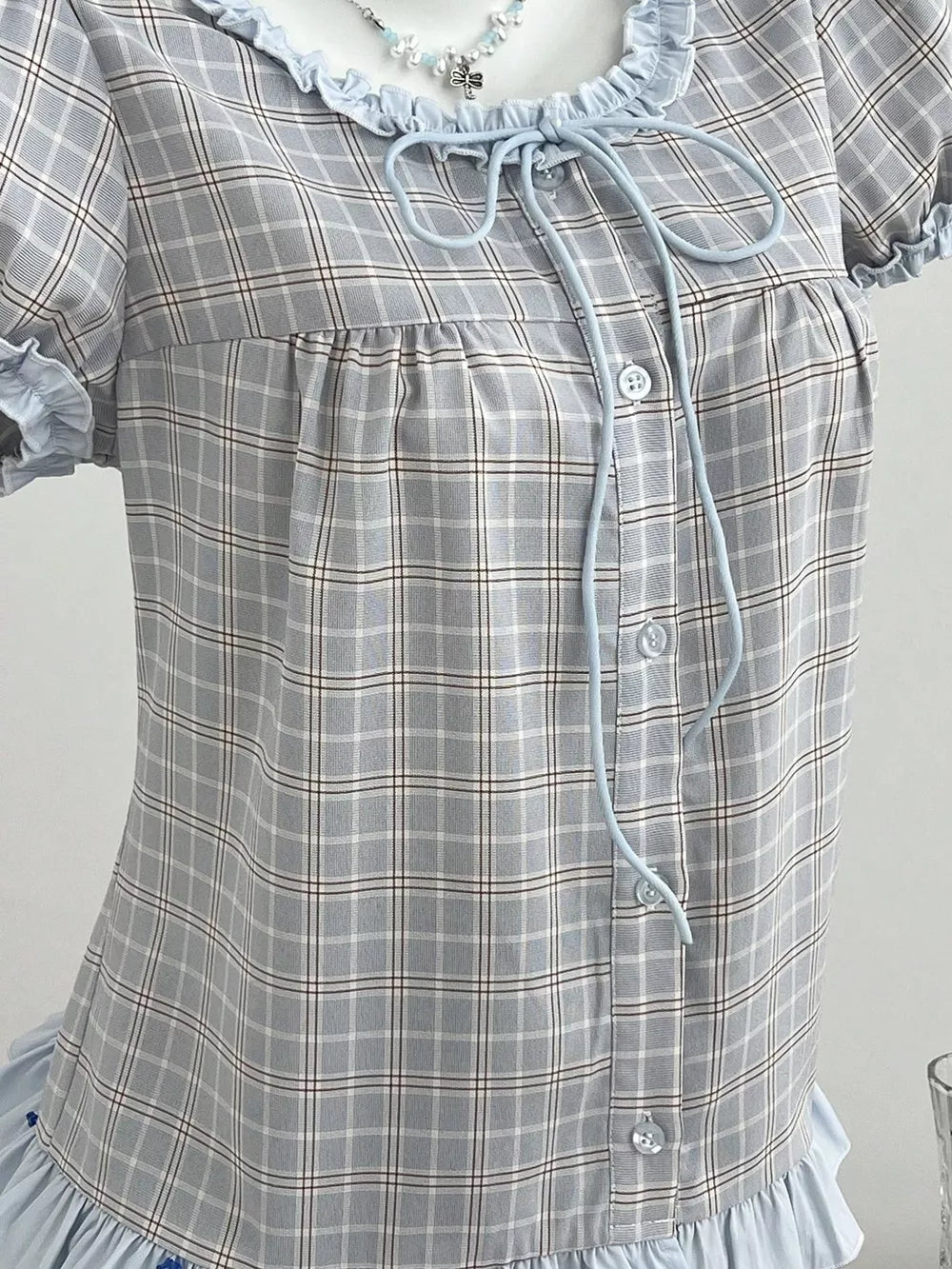 light blue blouse featuring tied and plaid