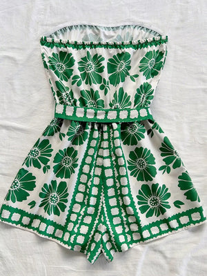 Green floral tie-waist strapless romper with a ruffled hem and playful geometric print.