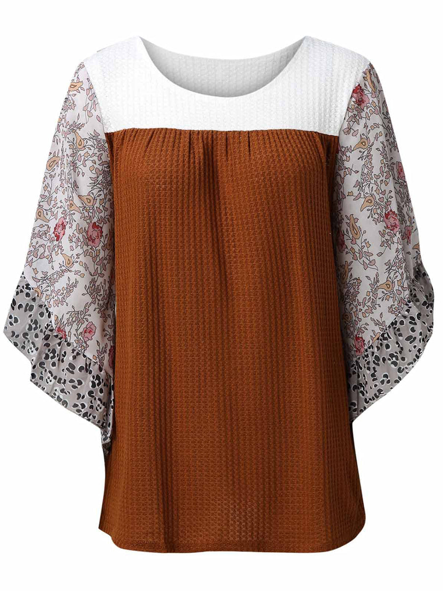 Textured panel blouse with floral flutter sleeves and round neckline.