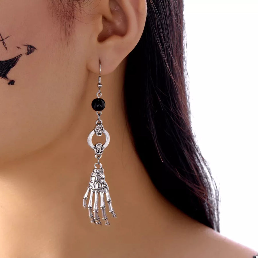 black earrings featuring drop earrings and figurative
