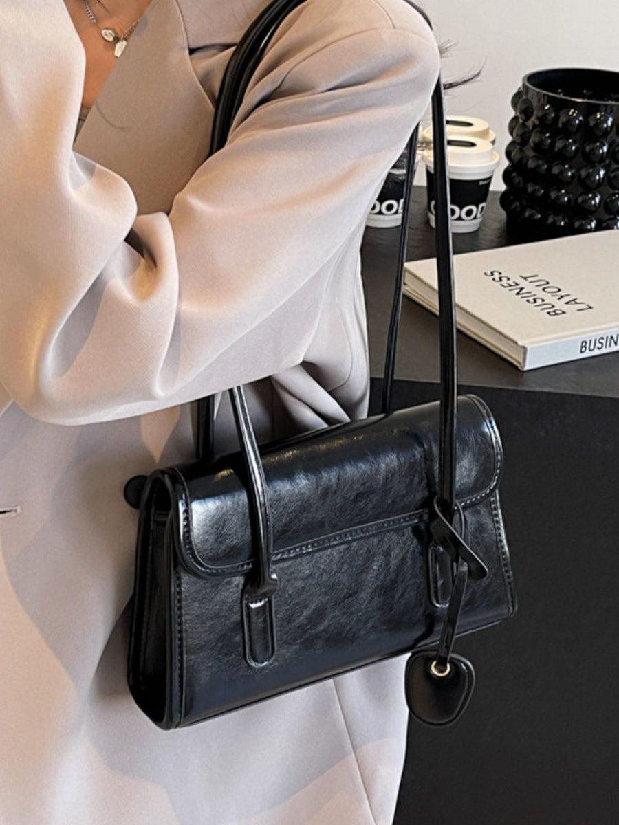 shoulder bag in Black with flap closure and small