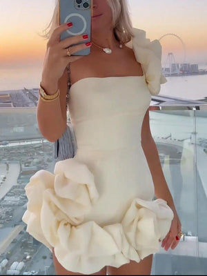 Cream ruffled one-shoulder mini dress with fitted bodice and voluminous skirt detail.
