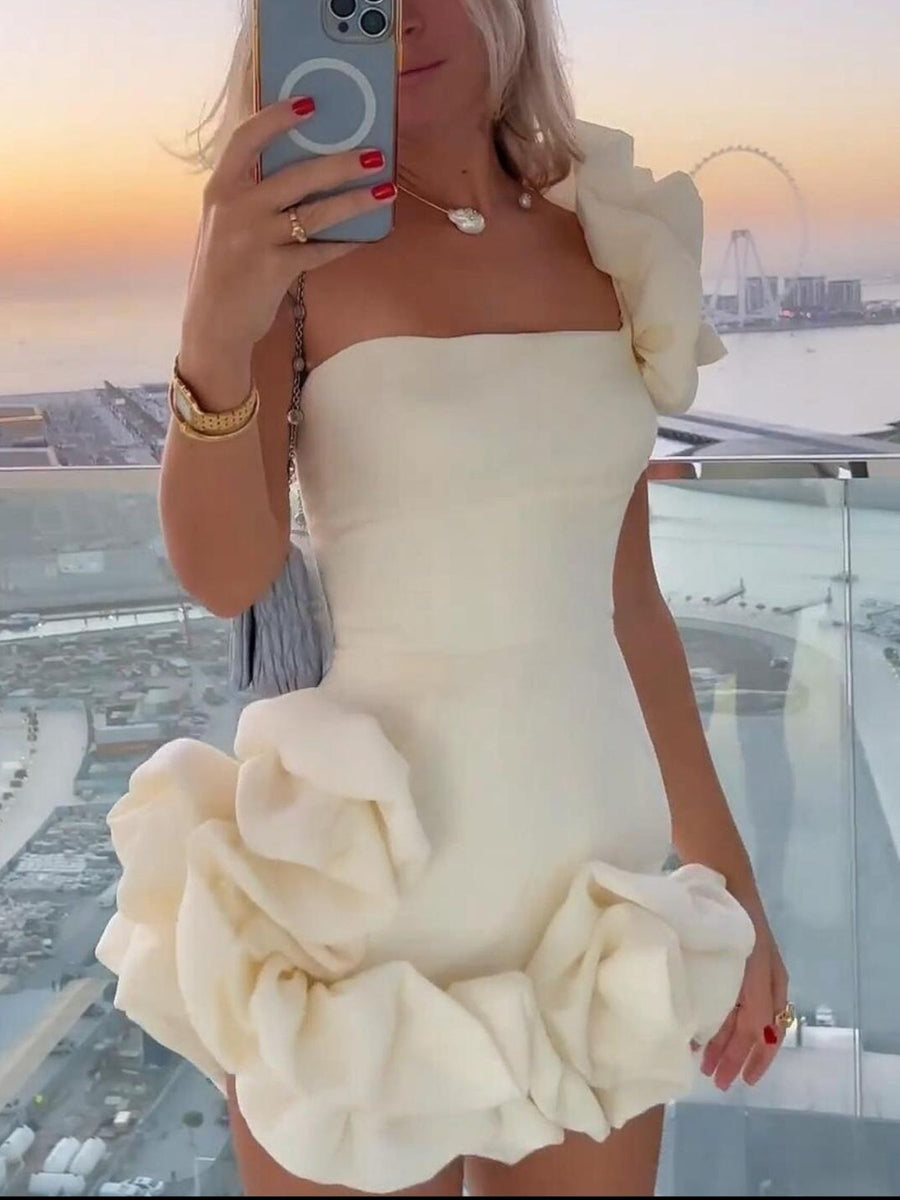 Cream ruffled one-shoulder mini dress with fitted bodice and voluminous skirt detail.