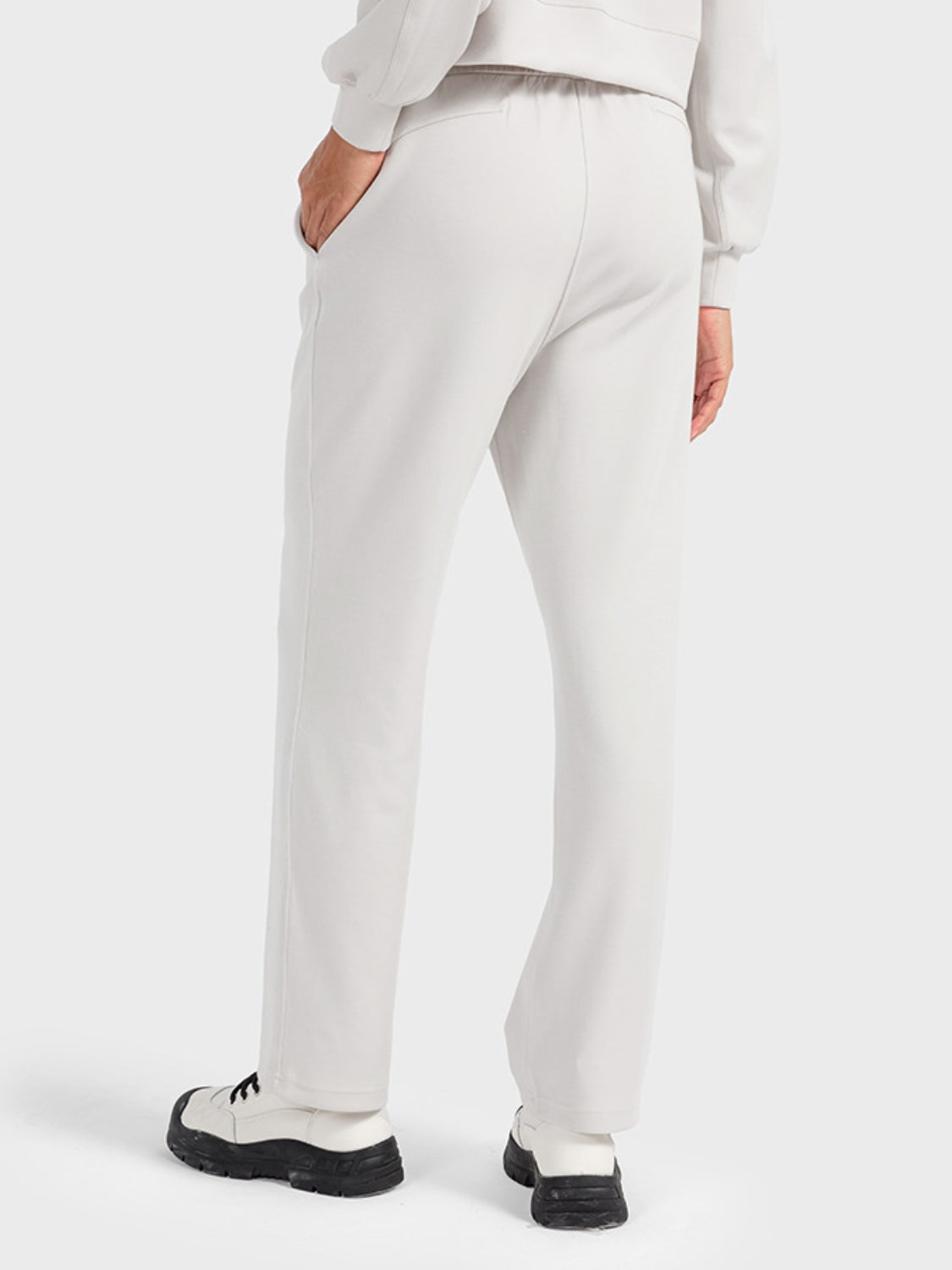 Ivory joggers with drawstring waist and pockets, relaxed fit.