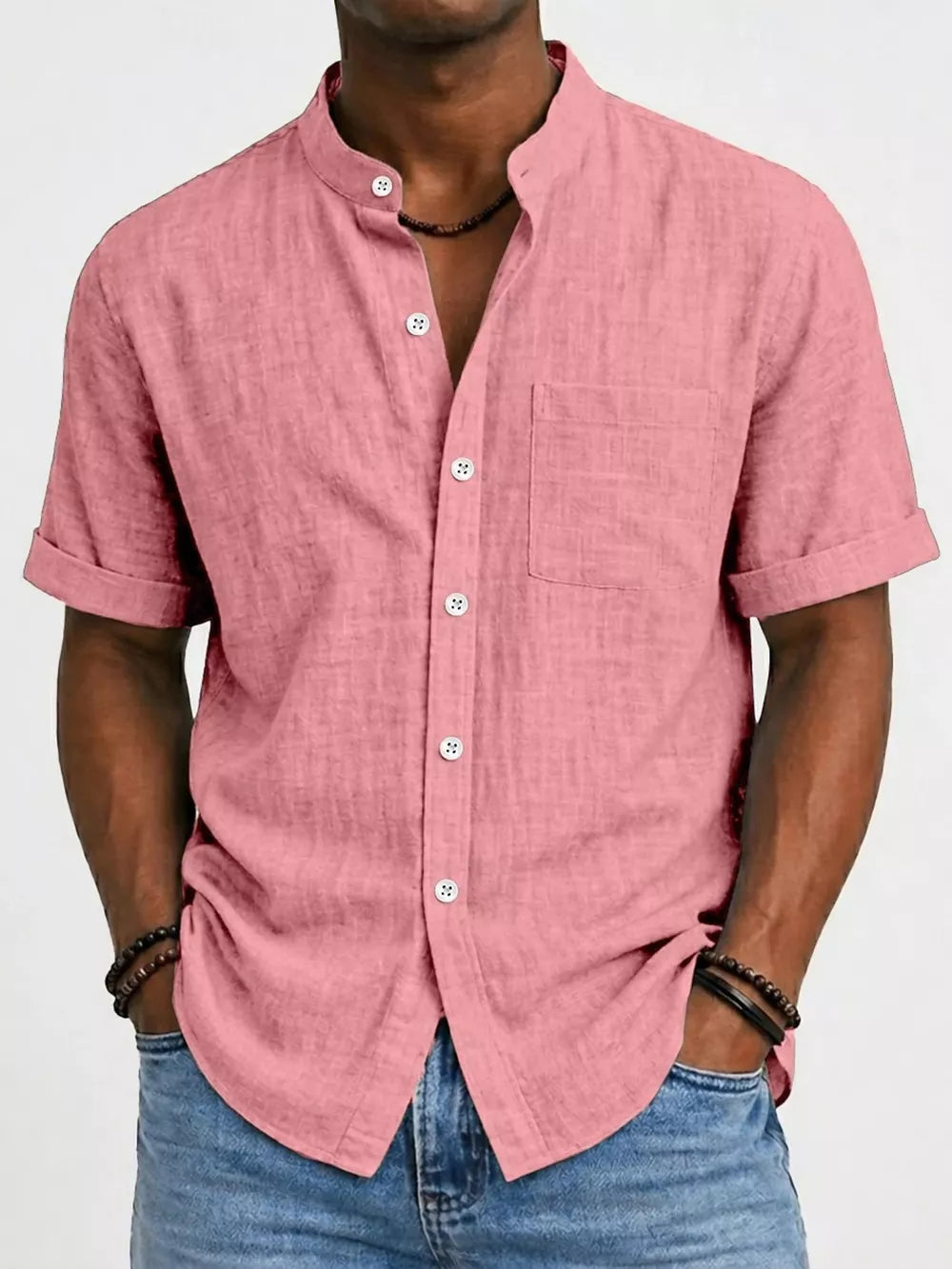 Pink textured band collar short sleeve cotton overshirt with button-up front and chest pocket.