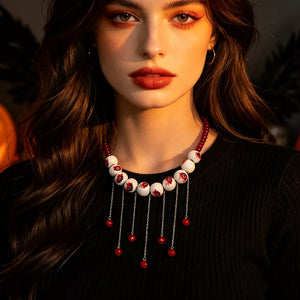 red necklace featuring eyeball motifs and eyeball motif