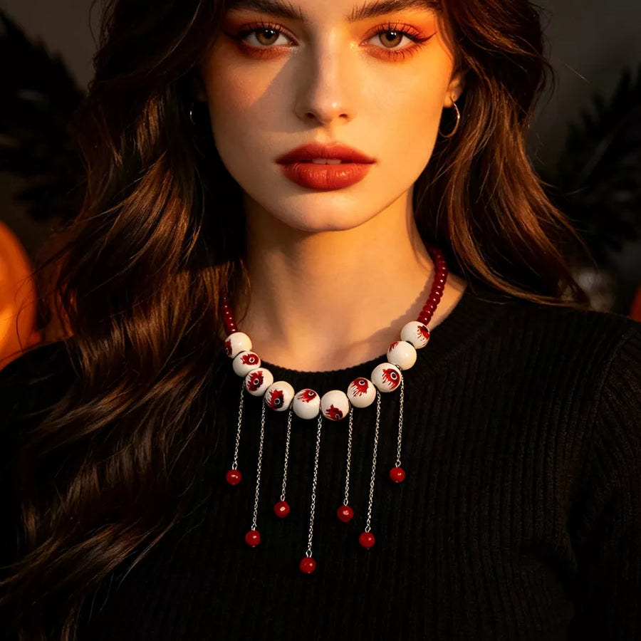 red necklace featuring eyeball motifs and eyeball motif