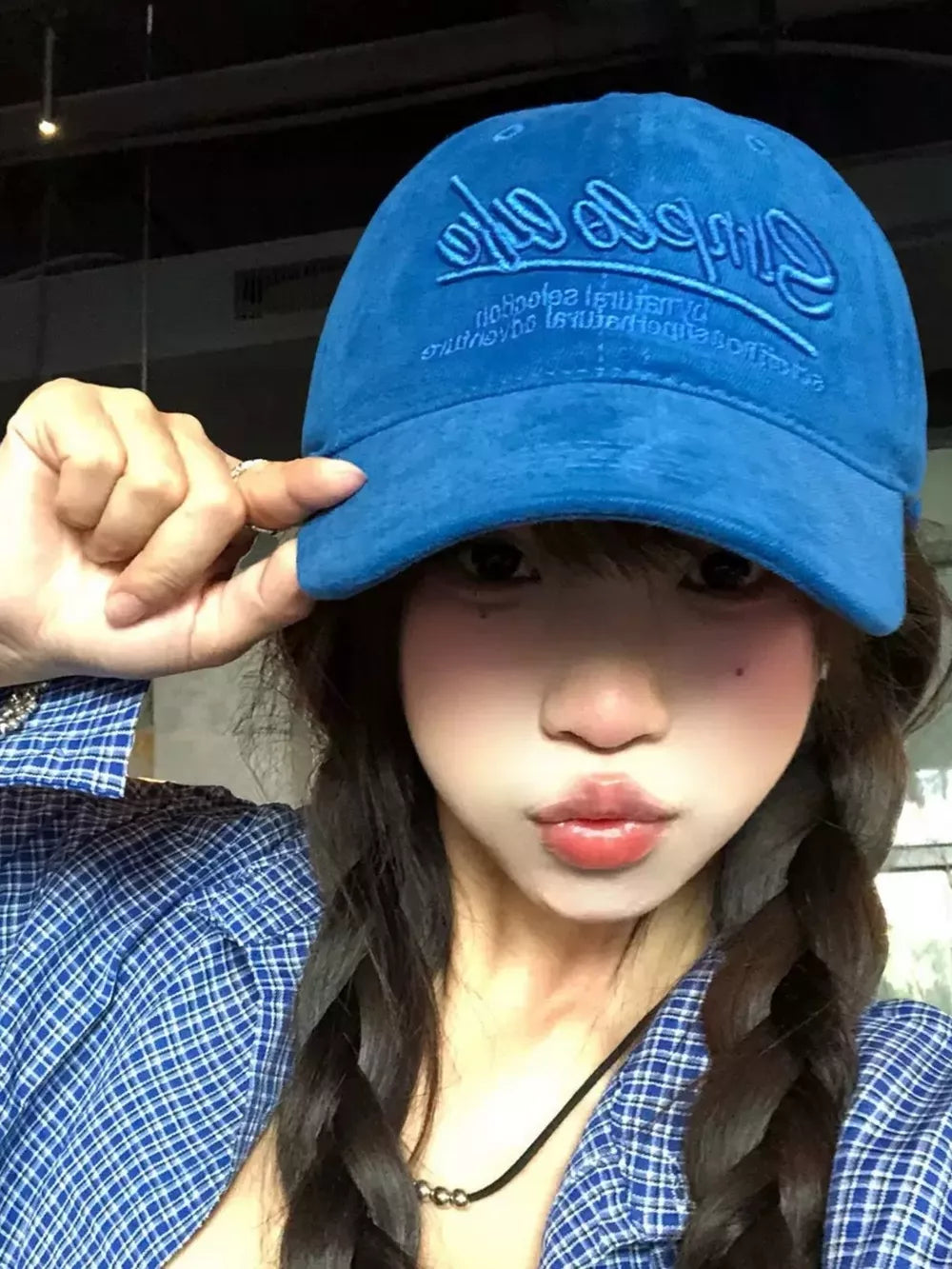 Royal blue cotton baseball hat with cursive embroidery