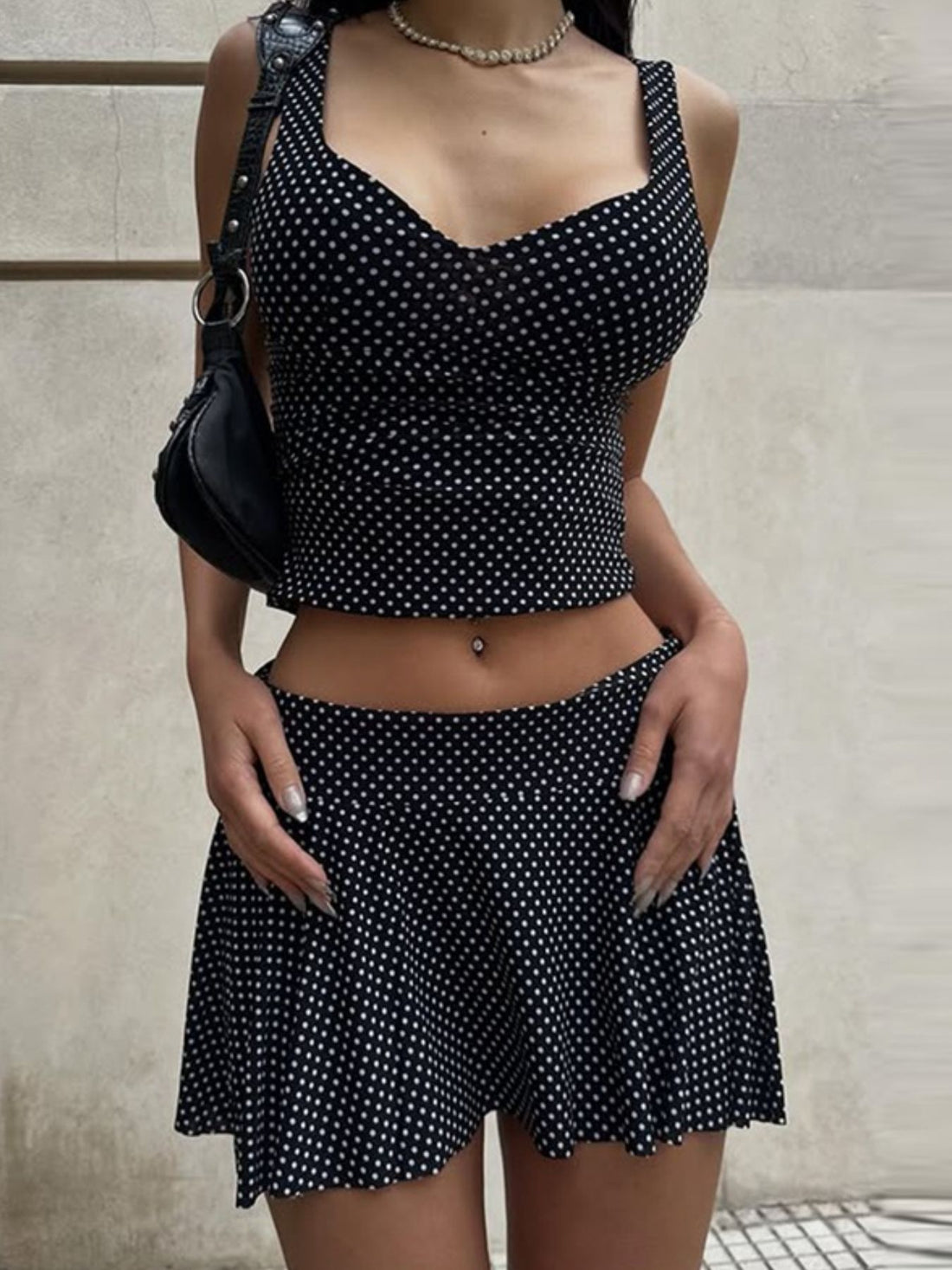 Black polka dot crop top and flared mini skirt set with sweetheart neckline