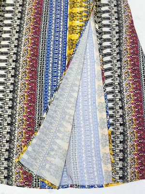 Bohemian maxi dress with colorful vertical stripes and a high slit.