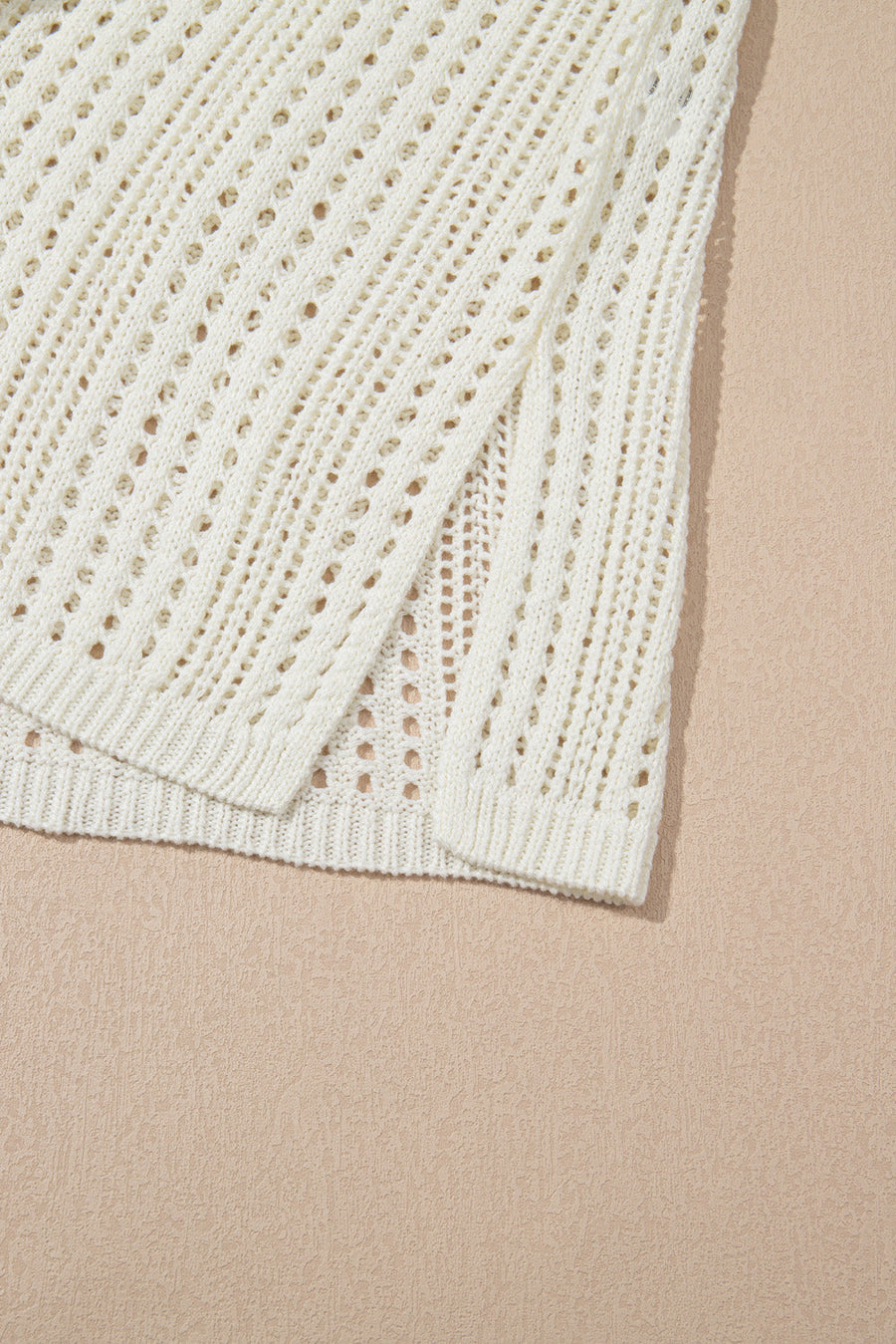 Beige open-knit mini dress with drawstring waist and side slit detail