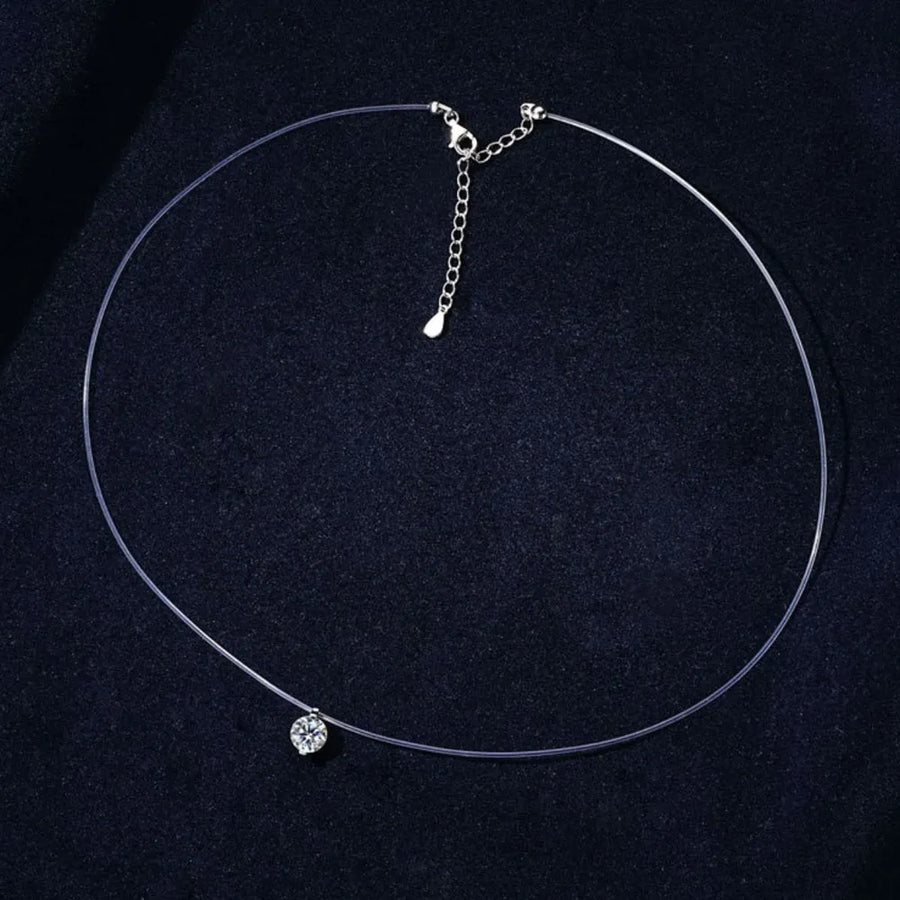 Silver floating moissanite necklace with clear wire and adjustable chain.