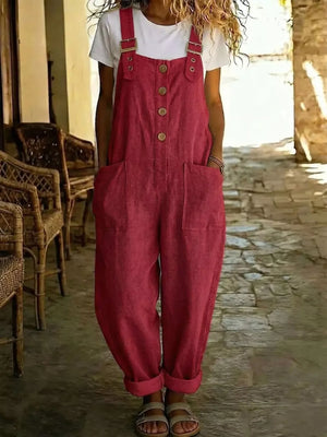 Red button-front wide leg romper with pockets and adjustable straps, worn over a white t-shirt.