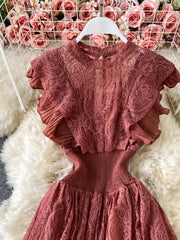 Elegant ruffled lace maxi dress in rose pink with pleated short sleeves and a cinched waist.