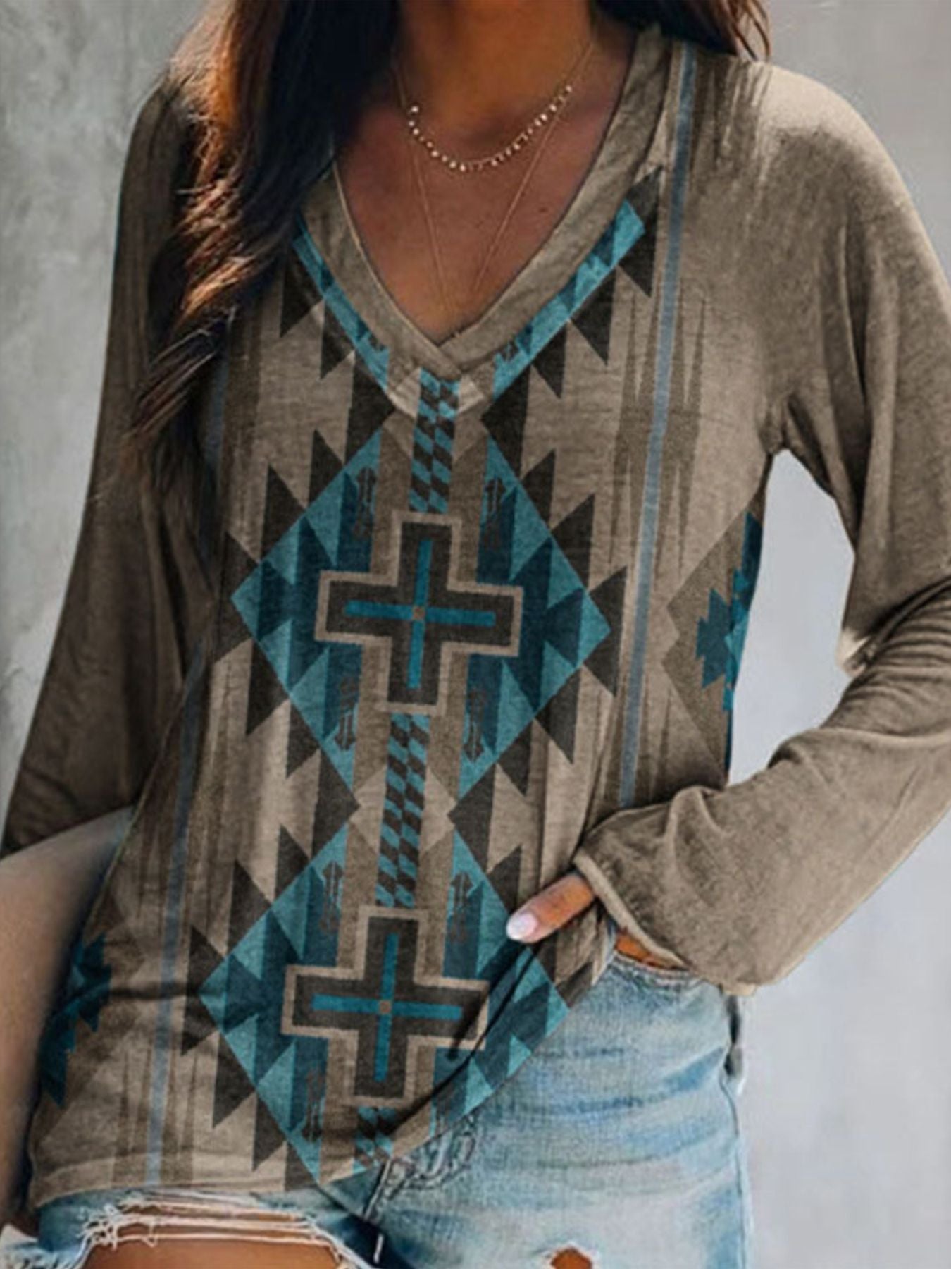Geometric V-neck long sleeve t-shirt in brown with blue and black tribal pattern.