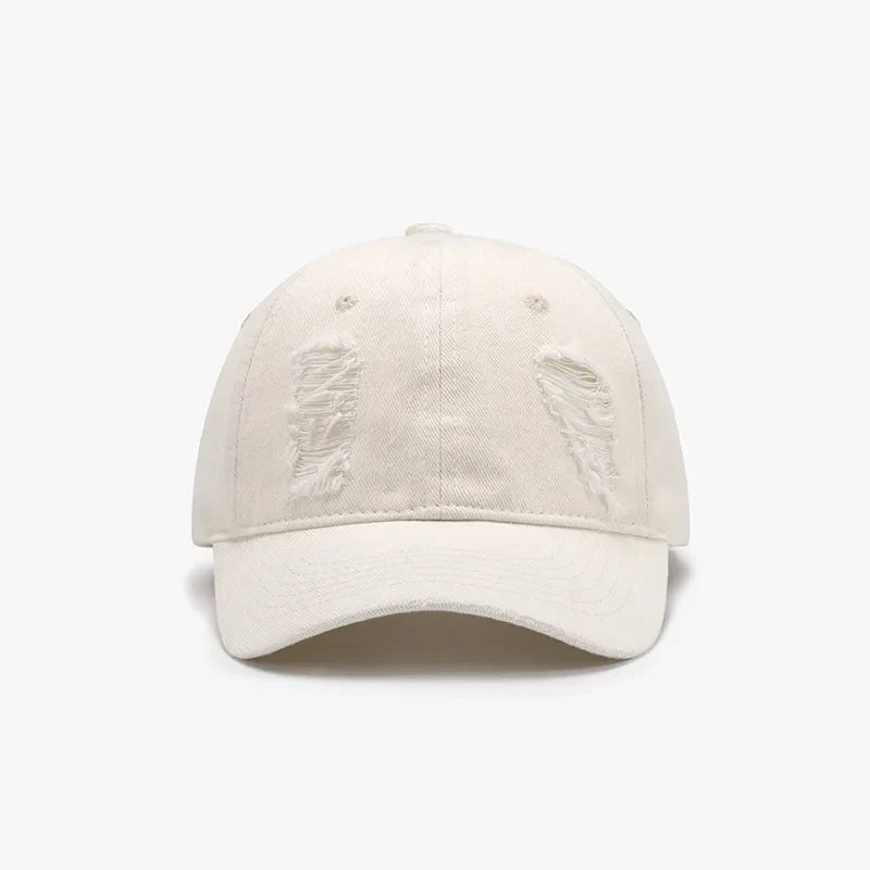 Ivory distressed denim baseball cap with ripped details.