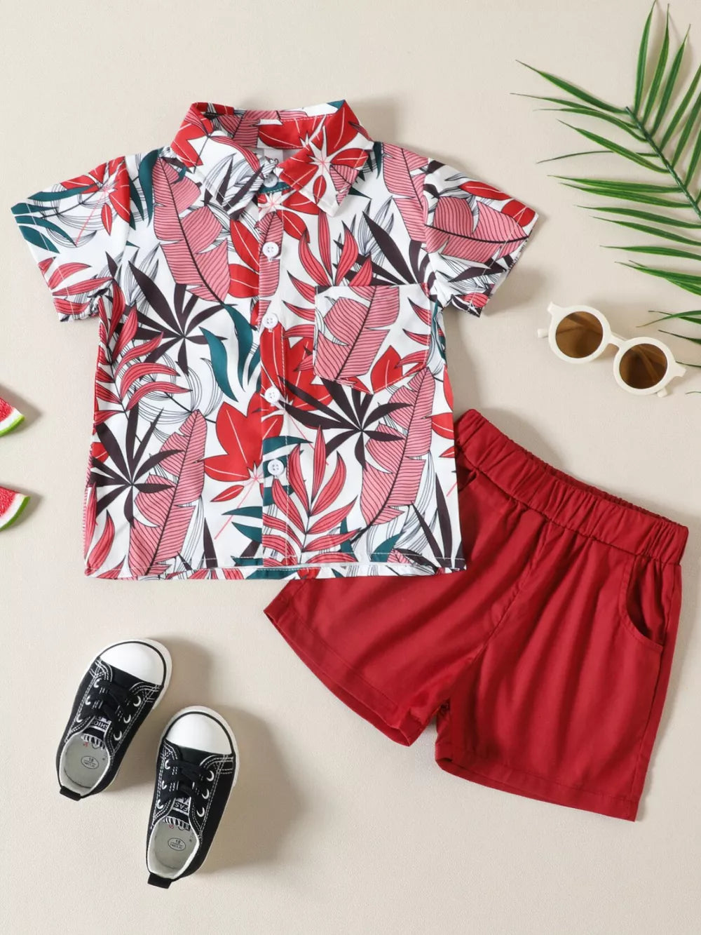 Toddler shirt and shorts set with tropical leaf print, button front shirt, red shorts.