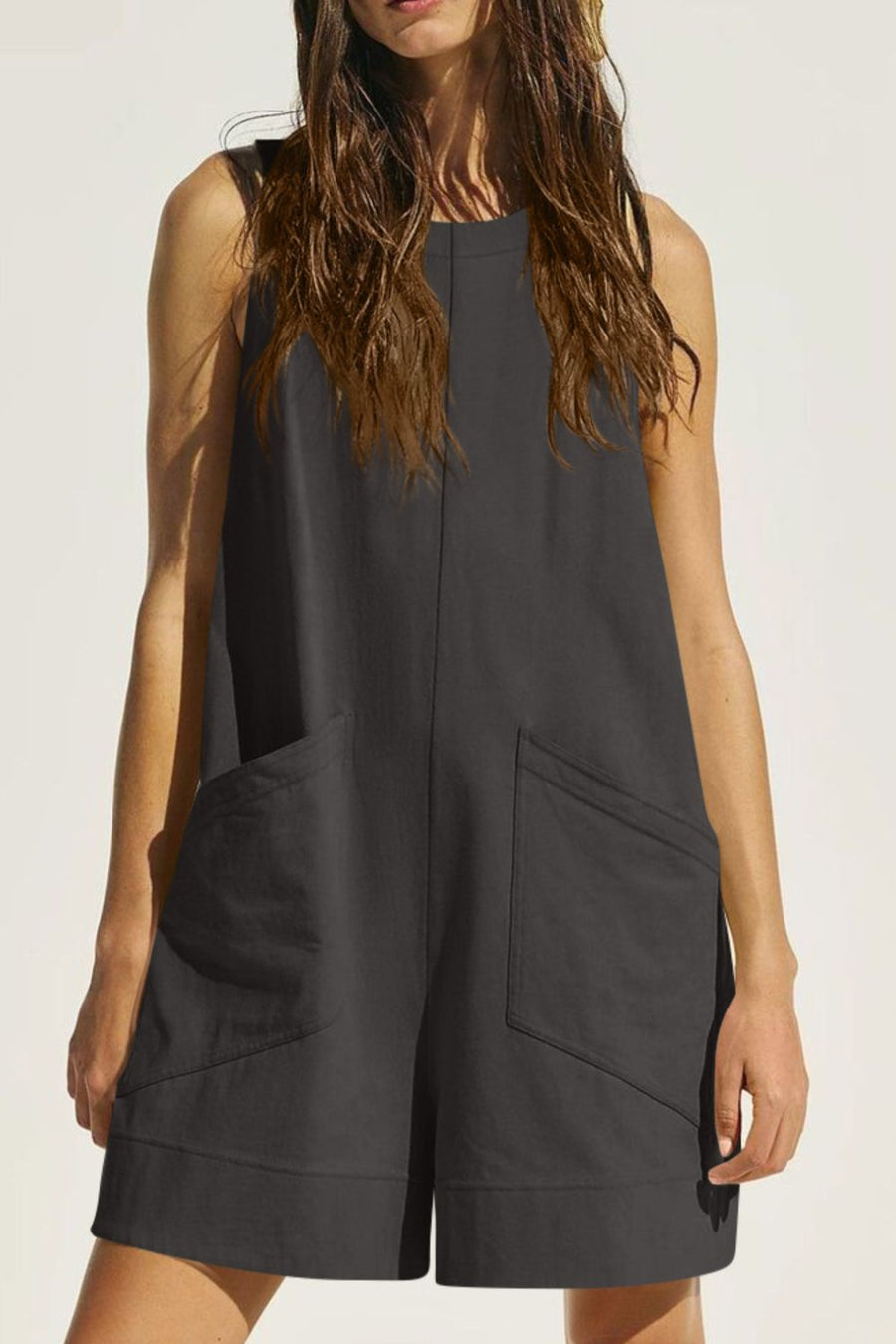 Dark gray linen romper with pockets and a relaxed fit.