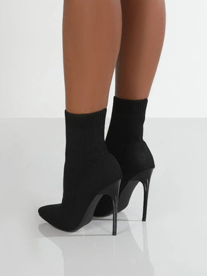 Black knit sock booties with pointed toe and stiletto heel.