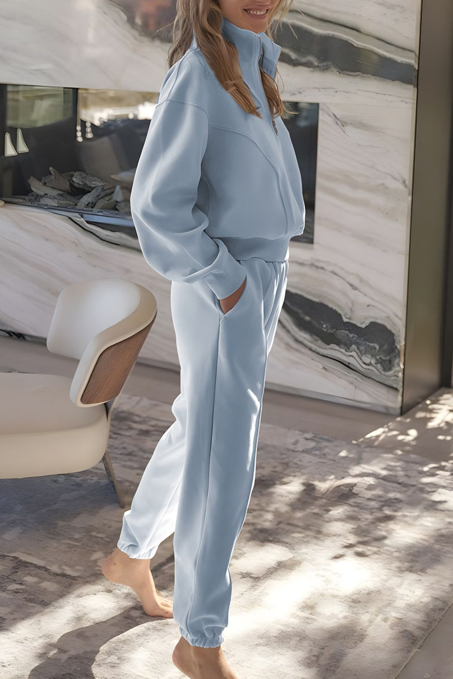 Light blue quarter-zip sweatshirt and jogger set with elastic cuffs and waistband.