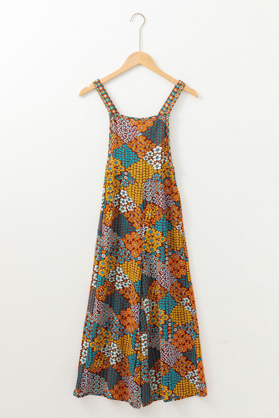 Floral patchwork culotte jumpsuit with wide legs and square neckline.