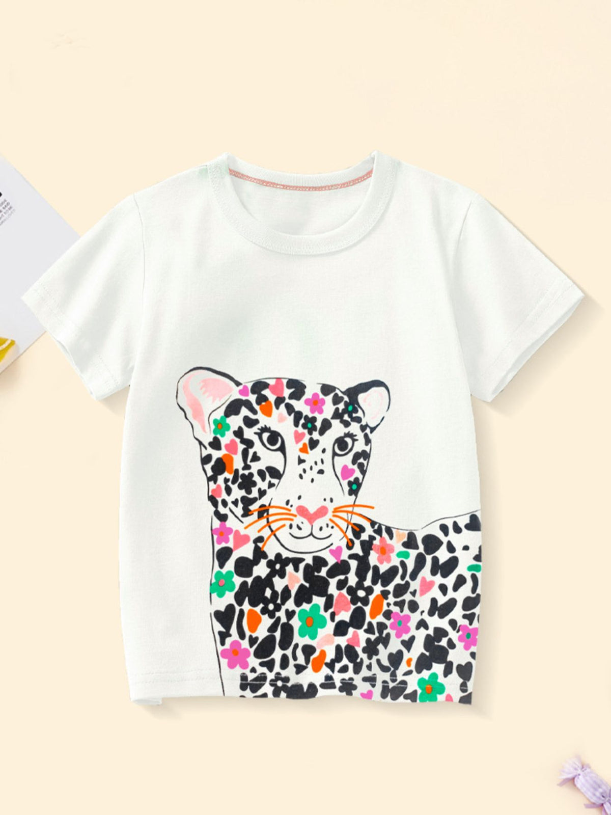 White cotton t-shirt with colorful floral leopard graphic print, crew neck, short sleeves.
