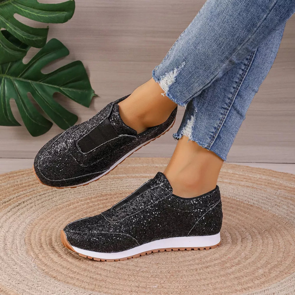 Black glittering round toe slip-on flats with elastic gore detail.