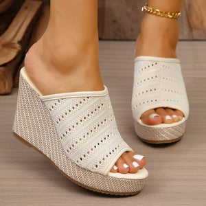 Beige perforated espadrille wedge sandals with woven wedge detail.